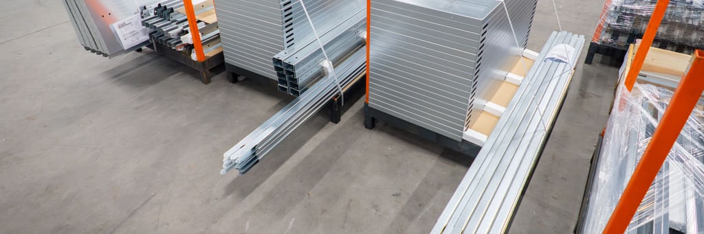 Stacked sheet metal parts and profiles in the production hall