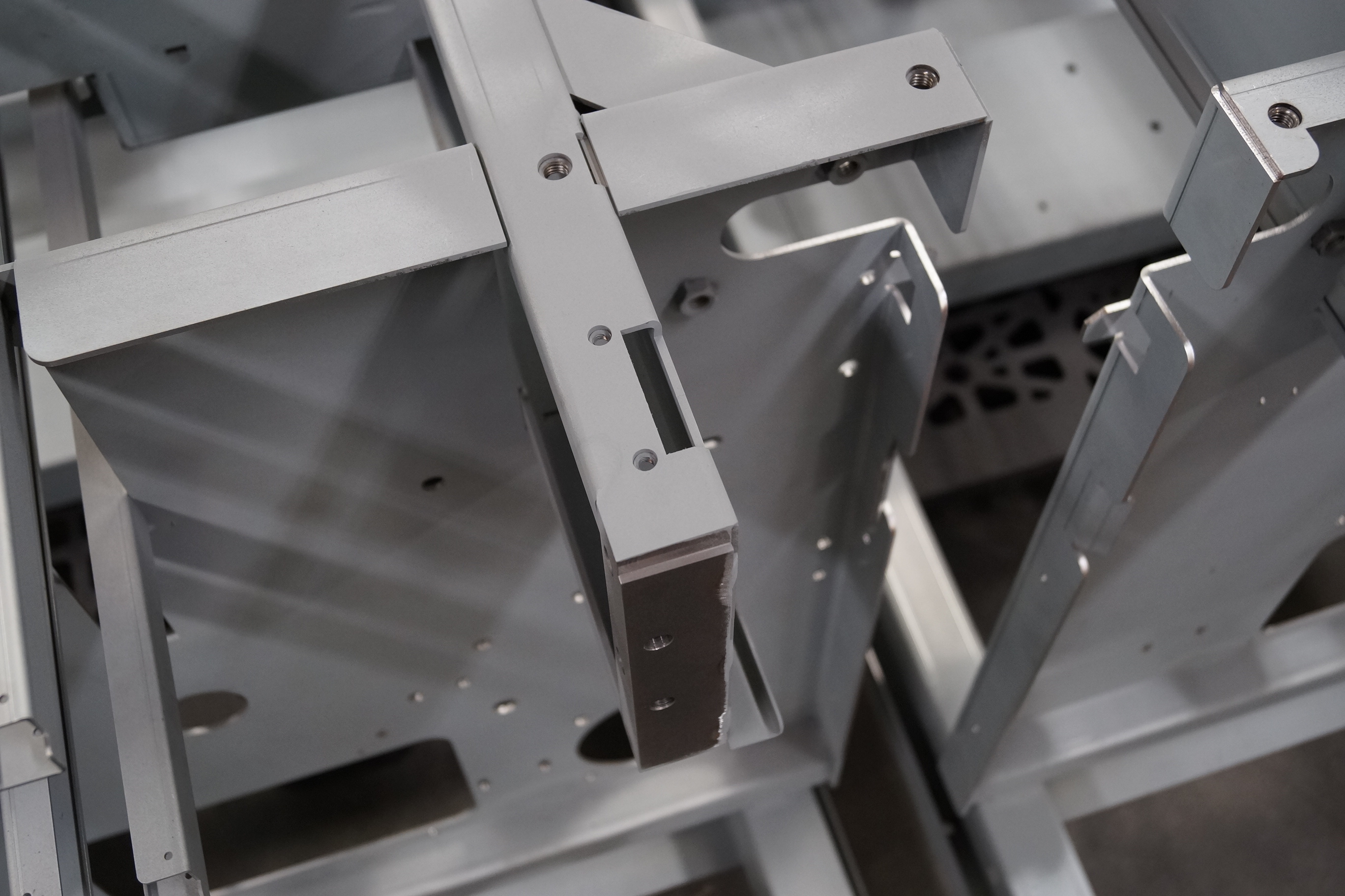Machine frame with weld nuts and milled blocks